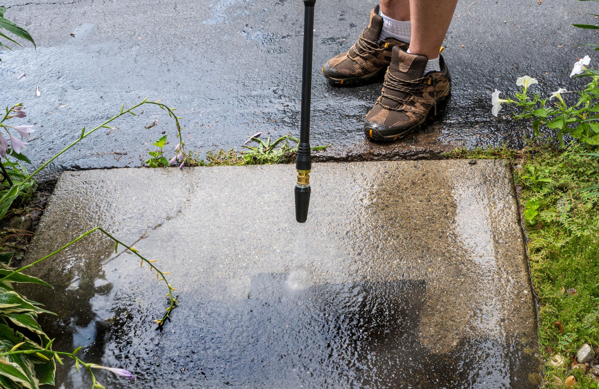 man washing off dirt. Man uses power washer, spring cleaning. Person cleans outside